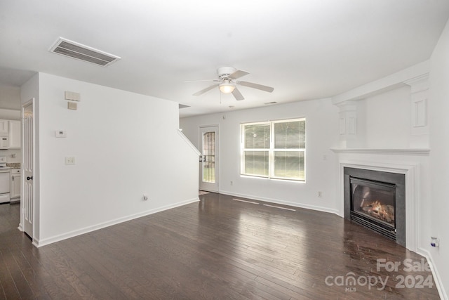 unfurnished living room with ceiling fan and dark hardwood / wood-style flooring