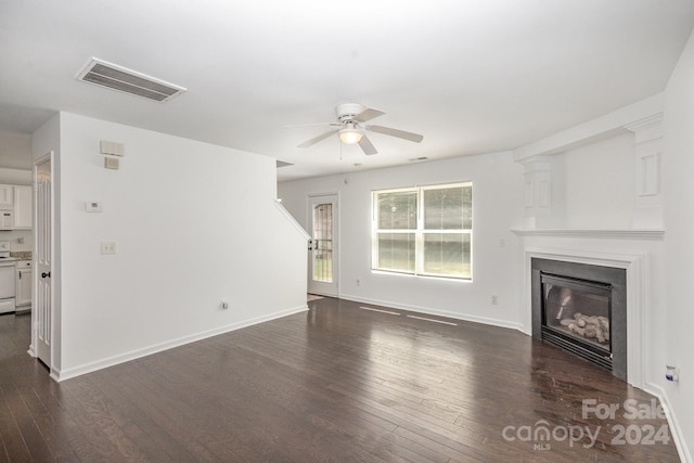 unfurnished living room with dark wood-type flooring and ceiling fan