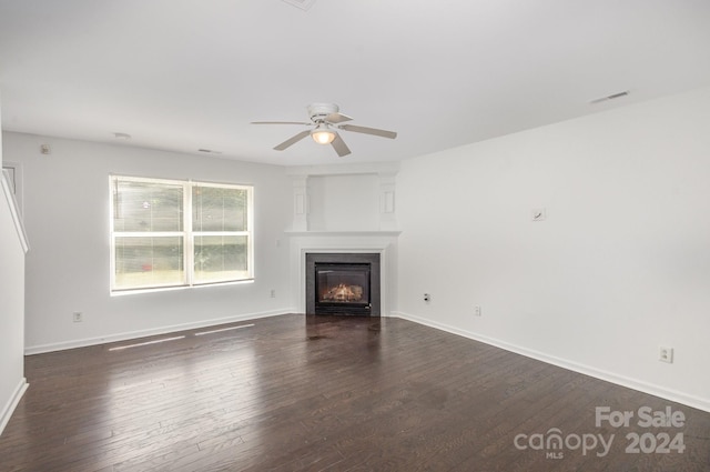 unfurnished living room with ceiling fan and dark hardwood / wood-style floors