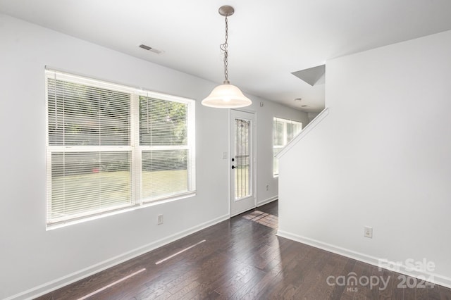 unfurnished dining area with dark hardwood / wood-style flooring