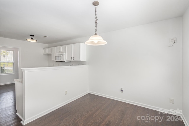 unfurnished dining area with dark hardwood / wood-style flooring