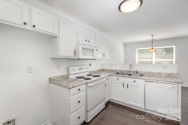 kitchen with white cabinetry, white appliances, dark hardwood / wood-style flooring, and sink