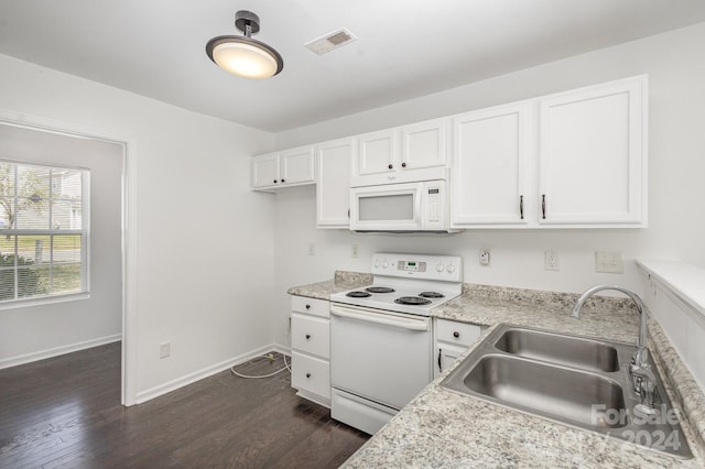 kitchen featuring dark wood-type flooring, sink, white appliances, and white cabinets