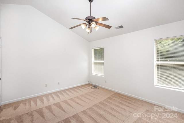 carpeted empty room featuring ceiling fan and vaulted ceiling