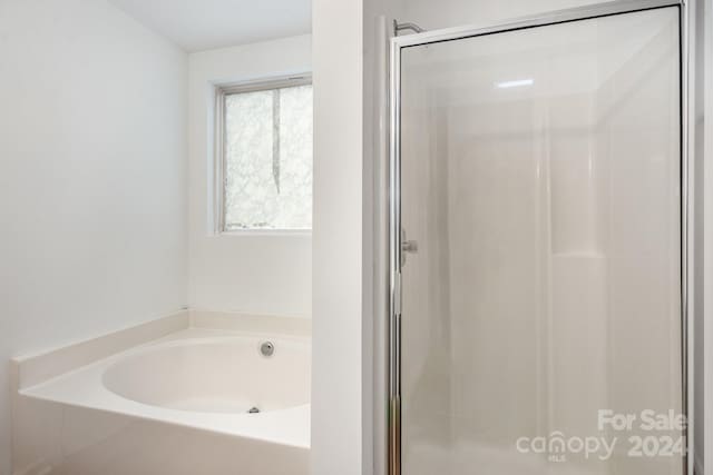 bathroom with plenty of natural light and independent shower and bath