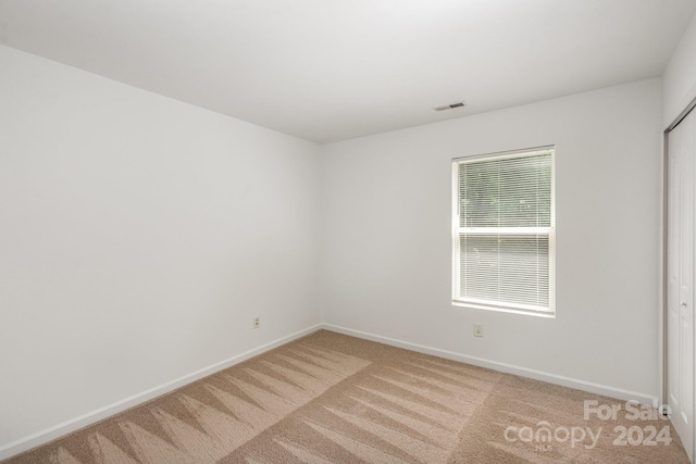 empty room featuring light colored carpet