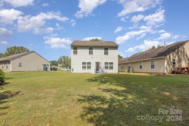 rear view of property featuring a yard