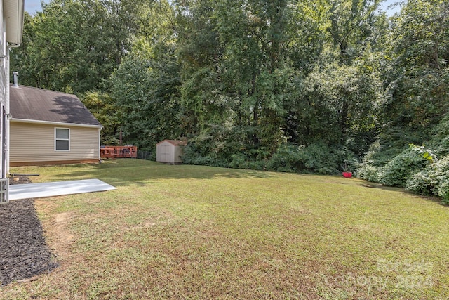 view of yard with a storage unit and a patio