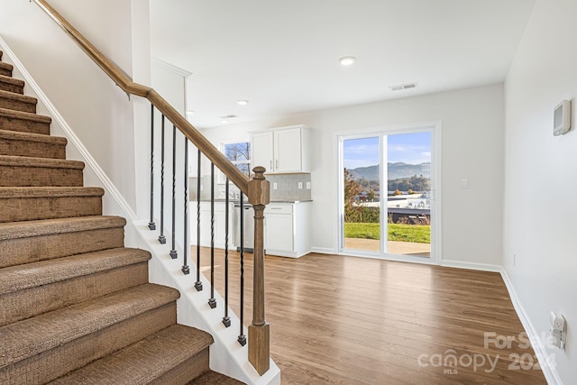 staircase with a mountain view and wood-type flooring