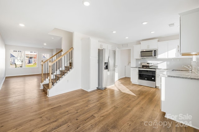 kitchen featuring white cabinets, light hardwood / wood-style floors, sink, and stainless steel appliances