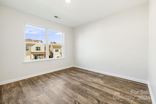 spare room with dark hardwood / wood-style flooring