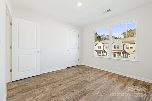 unfurnished bedroom featuring hardwood / wood-style flooring