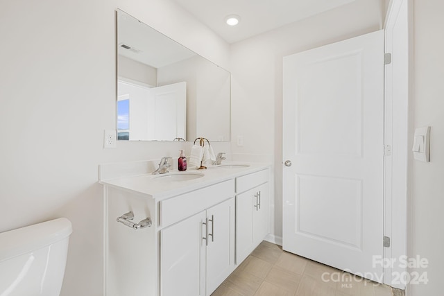 bathroom featuring vanity and toilet