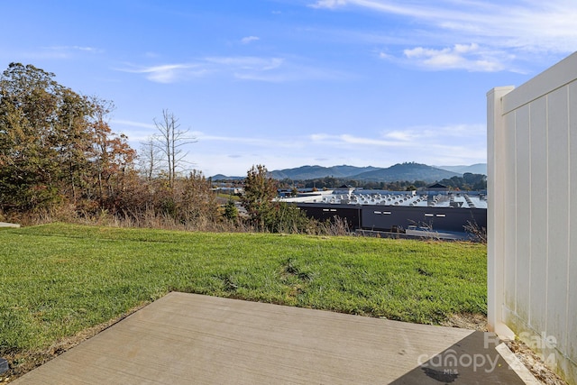 view of yard featuring a deck with mountain view