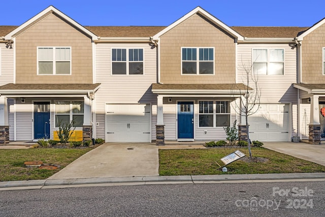 townhome / multi-family property featuring a garage