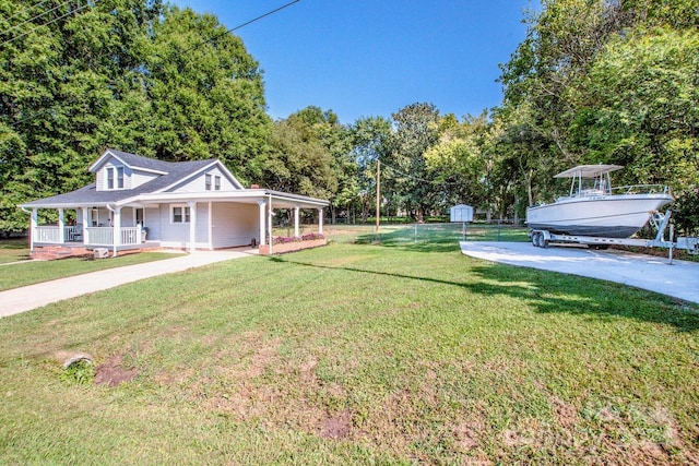 view of front facade featuring a front yard, a porch, and a shed