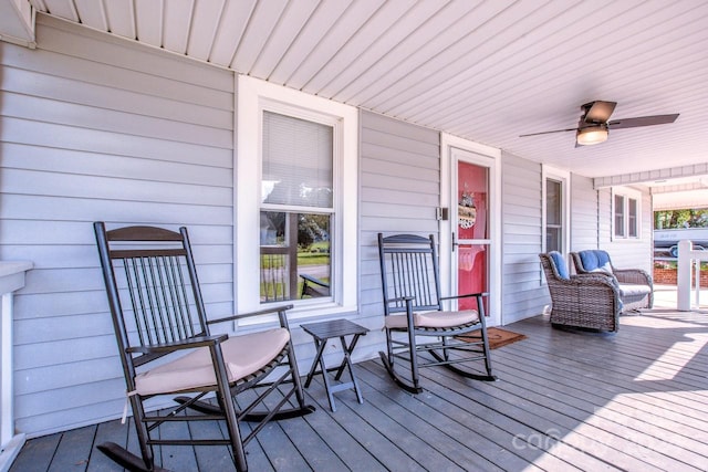 wooden terrace with a porch and ceiling fan