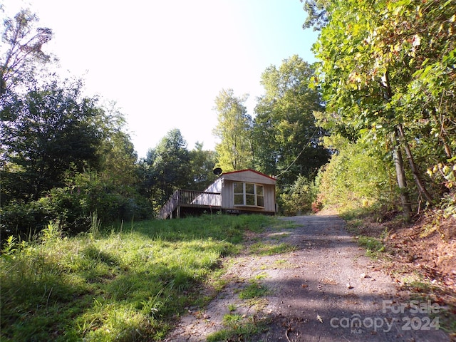 view of front of house featuring driveway and a deck