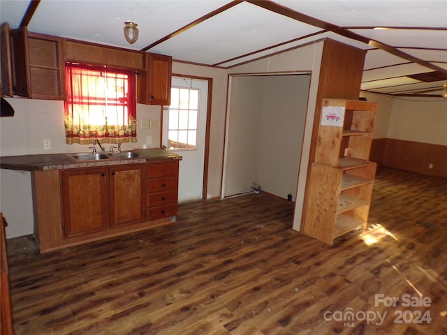 kitchen featuring dark wood-style floors, brown cabinetry, and a sink