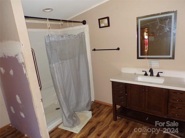 bathroom featuring ornamental molding, vanity, a shower with shower curtain, and wood finished floors