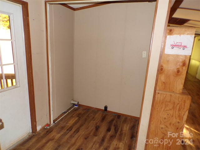 clothes washing area with plenty of natural light and wood finished floors