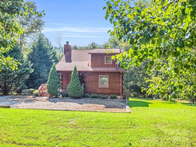 view of home's exterior featuring a chimney and a lawn