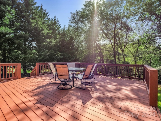 wooden terrace featuring outdoor dining area