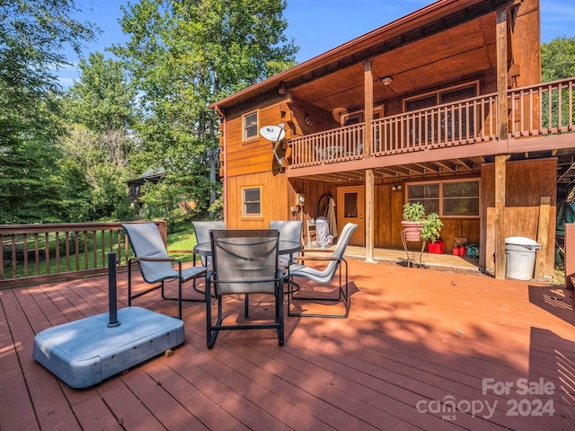 wooden terrace with outdoor dining space