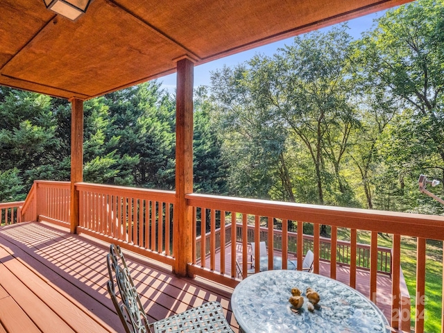 wooden terrace with outdoor dining space