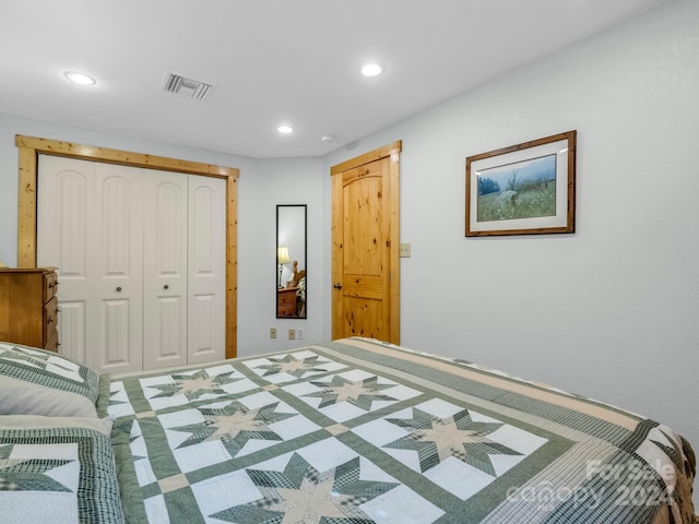 bedroom with carpet floors, visible vents, a closet, and recessed lighting