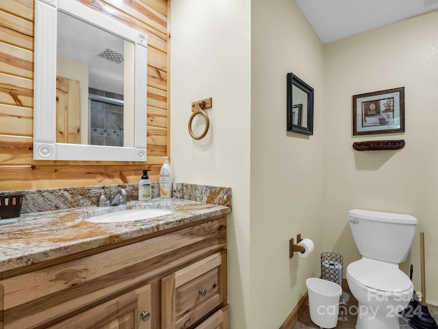 bathroom with toilet, baseboards, and vanity