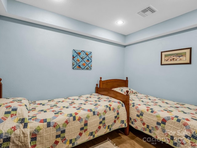 bedroom with wood finished floors, visible vents, and recessed lighting