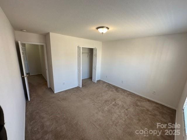 unfurnished bedroom featuring a closet and carpet flooring