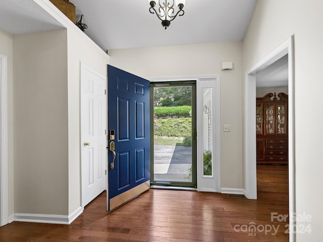 foyer featuring baseboards and hardwood / wood-style flooring