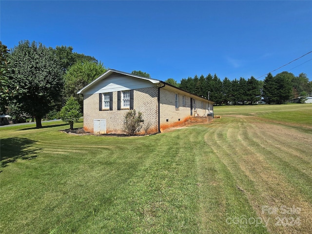 view of side of property with a yard