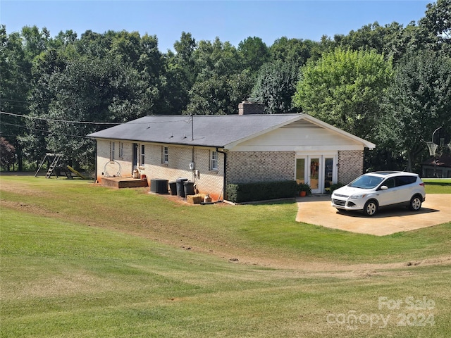 241 Eastview Dr, Bostic, NC 28018 - rear view of property featuring brick siding, a lawn, central AC, and a chimney