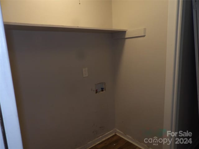 clothes washing area with hookup for a washing machine, laundry area, baseboards, and dark wood-style flooring