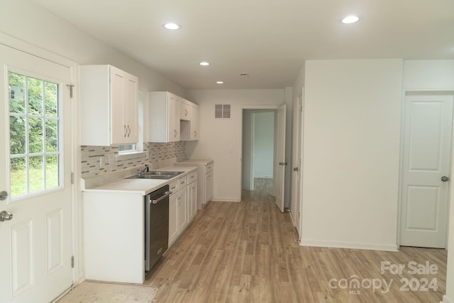 kitchen with light hardwood / wood-style flooring, dishwasher, sink, decorative backsplash, and white cabinets