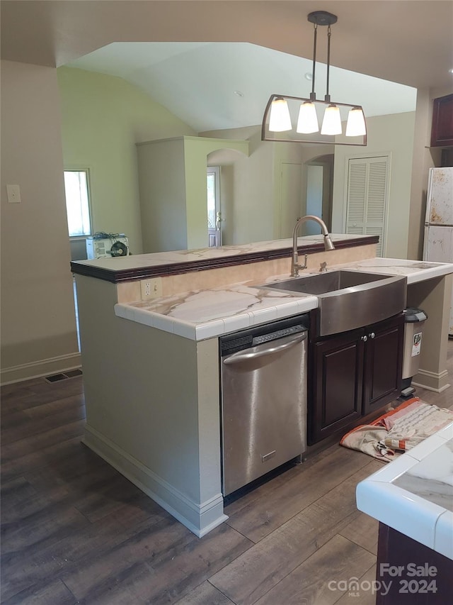 kitchen with dark hardwood / wood-style floors, a center island with sink, pendant lighting, stainless steel dishwasher, and sink