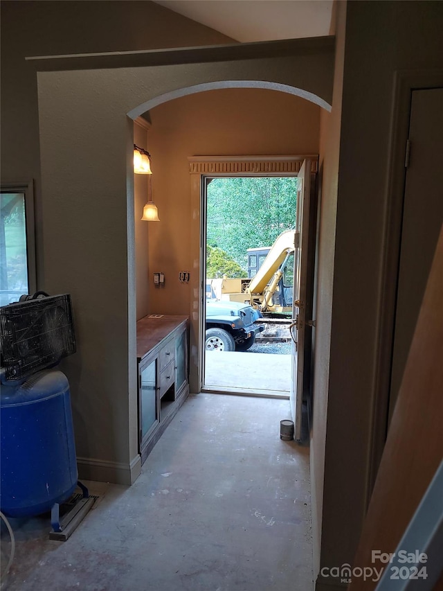 interior space with vaulted ceiling, concrete floors, and vanity