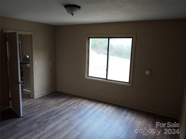 spare room with wood-type flooring