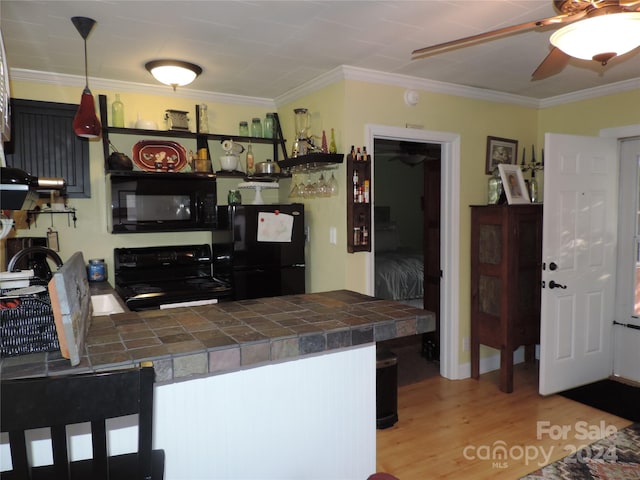 1555 Soco Rd Unit 6, Maggie Valley, NC 28751 - kitchen featuring black appliances, a ceiling fan, a peninsula, light wood-type flooring, and ornamental molding