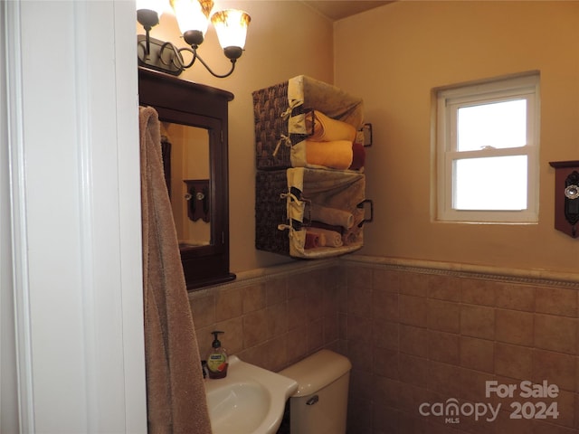 1555 Soco Rd Unit 6, Maggie Valley, NC 28751 - half bath featuring a chandelier, tile walls, and a wainscoted wall