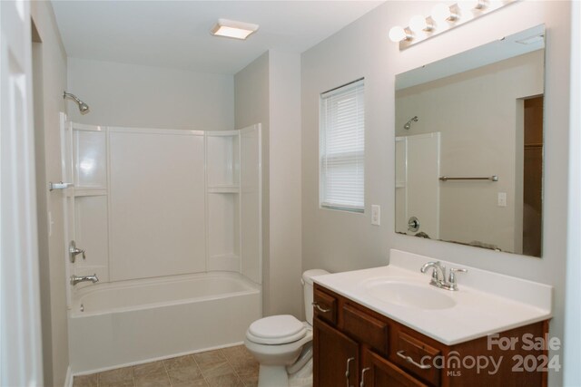 full bathroom featuring shower / bathtub combination, vanity, toilet, and tile patterned floors