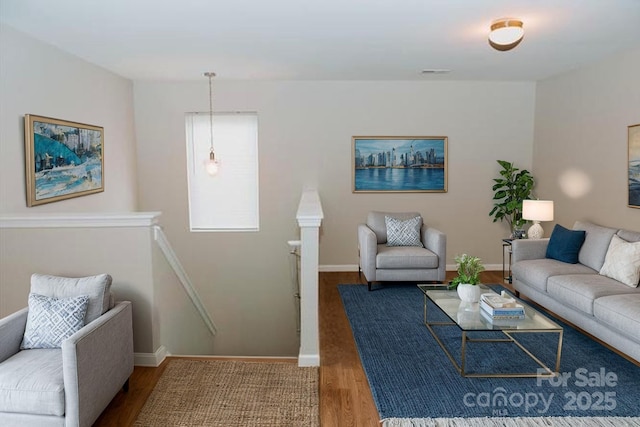 living room featuring baseboards and wood finished floors