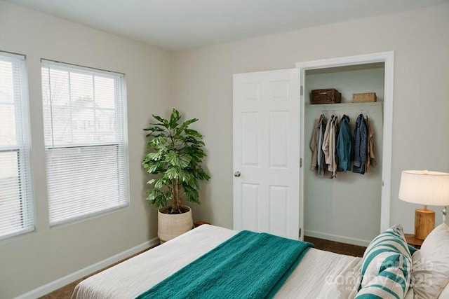 bedroom with baseboards and a closet