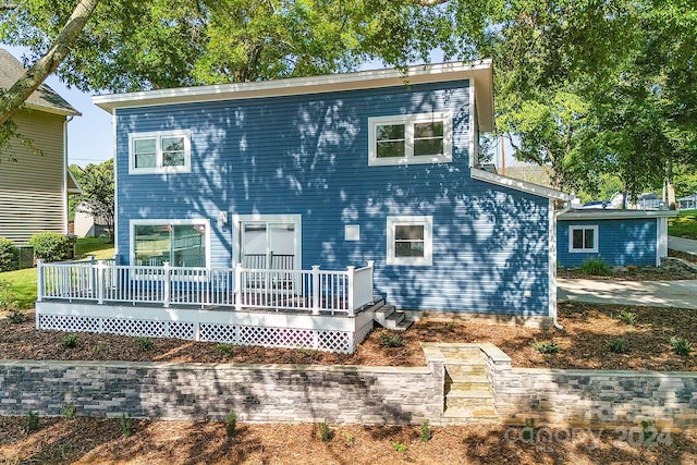 back of house featuring a deck