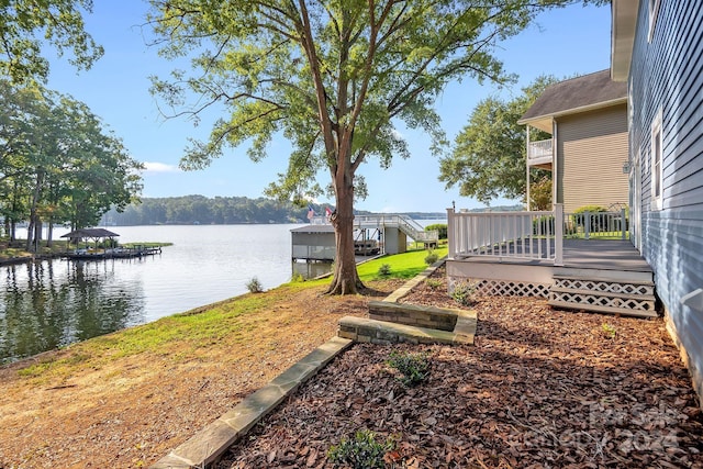 view of yard with a water view and a boat dock