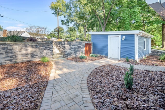 view of outbuilding with fence and an outdoor structure