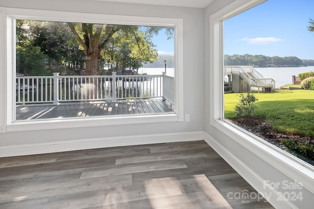 unfurnished sunroom with a water view